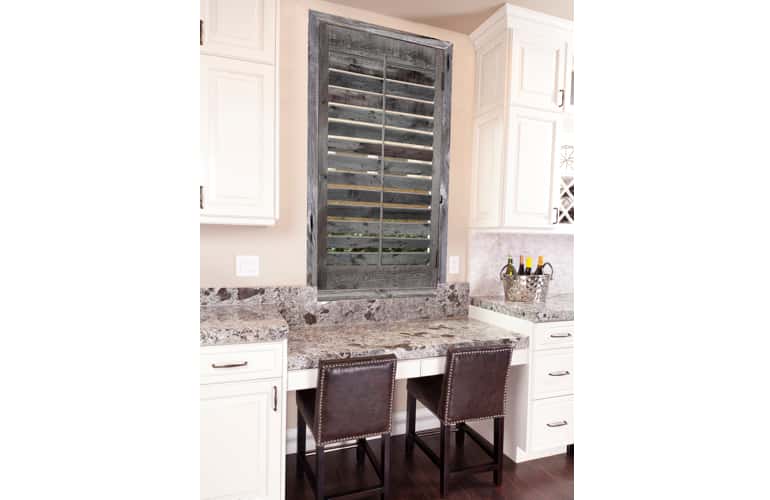 Kitchen window with reclaimed wood shutters in Fort Myers